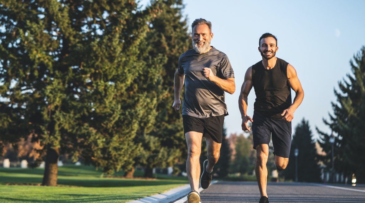 The happy father and a son running on a park road